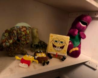 Plush character toys including SpongeBob and Barney
