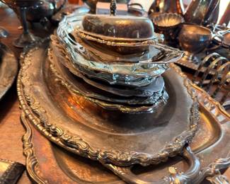 Stacked silverplate serving trays and platters