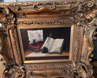 Ornate gold gilt framed still life painting of books and inkwell
