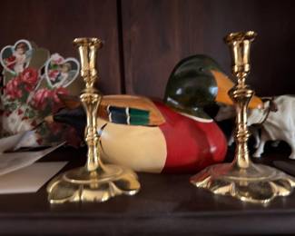 Pair of brass candlesticks with carved wood duck decoy