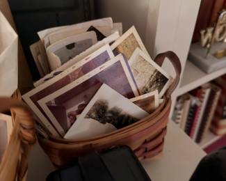 Basket of antique photographs and a vintage journal