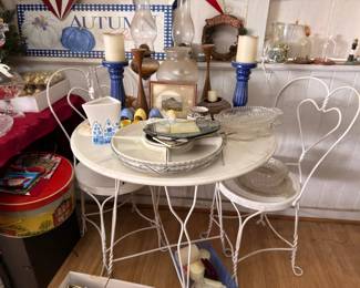 White wrought iron ice cream parlor table with marble top and seasonal decor