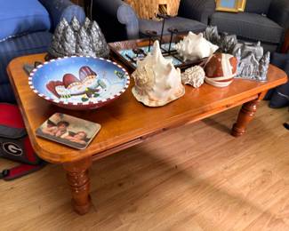 Wood coffee table with conch seashells and decorative pieces