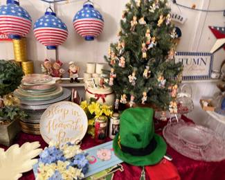 Assorted holiday decor, tabletop Christmas tree, patriotic lanterns and seasonal accents