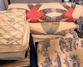 Handmade quilts including double wedding ring pattern and blue toile linens