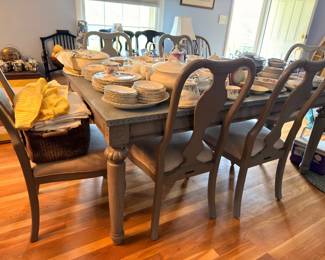 Dining table with Queen Anne chairs set with china