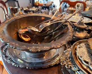 Silverplate serving bowl with spoons and flatware