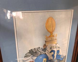 Framed football artwork with player and championship trophy