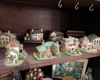 Miniature ceramic village house figurine collection on shelf