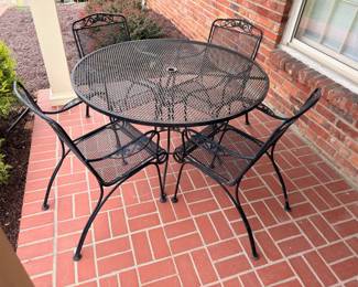 Round wrought iron mesh patio table and chairs