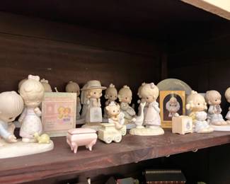 Precious Moments porcelain figurine collection, shelf display