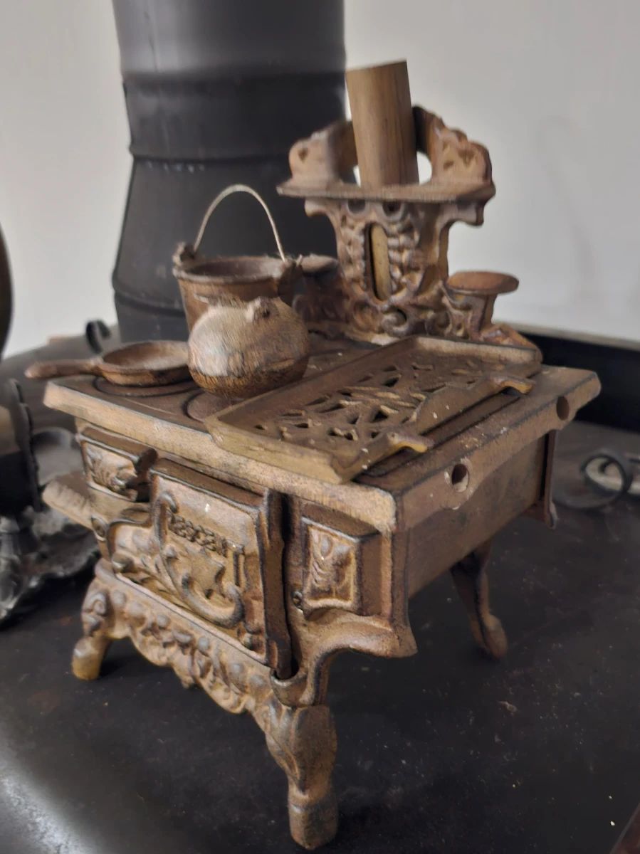 Mini cast iron stove with pots and pans