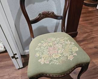 Slender chair with embroidered seat