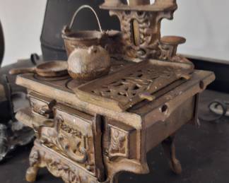 Mini cast iron stove with pots and pans