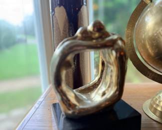 Brass praying hands sculpture on black base