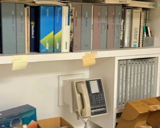 Office shelving with binders and phone
