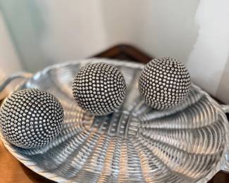 Silver decorative spheres in wire bowl