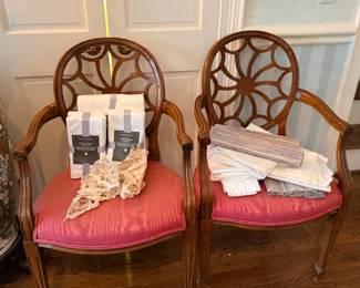 Pair of carved wood armchairs, red cushions