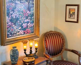 Striped armchair, lamp and framed art