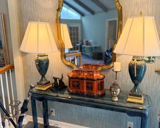 Console table with pair of lamps and gilt mirror