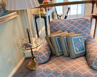 Upholstered armchair with brass floor lamp