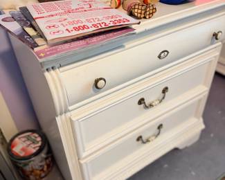 White nightstand with collectibles