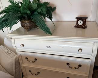 White dresser with fern and clock