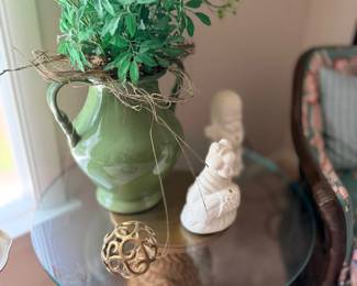 Green ceramic pitcher with greenery