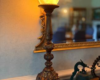 Ornate metal table lamp with amber glass shade