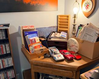 Desk with model cars and karaoke machine