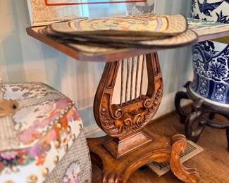 Carved lyre-base side table