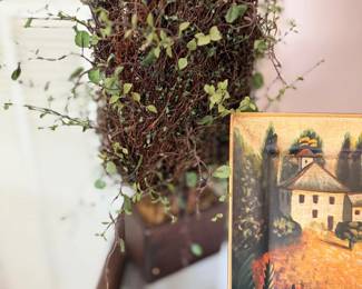Faux greenery topiary and framed art