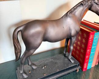 Bronze horse sculpture with books