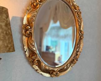 Ornate gilt oval wall mirror