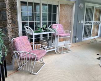 White iron patio chairs with pink cushions