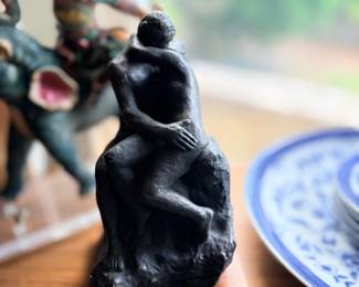 Carved figural sculptures on wood stands