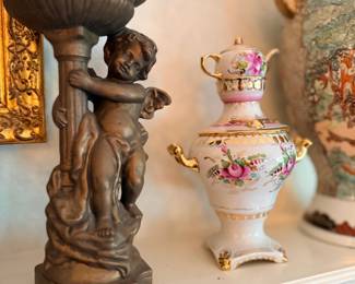 Figural cherub candlestick and floral porcelain teapot