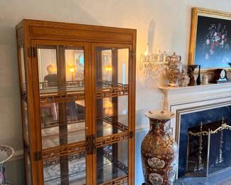 Lighted curio cabinet and large Asian floor vase