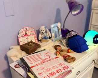White dresser with lamp and collectibles