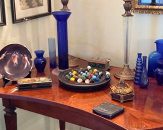 Demilune table with blue glass and decor
