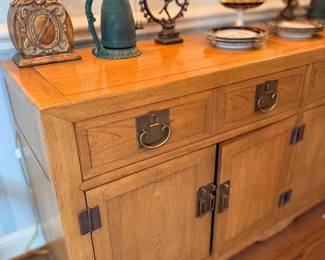 Wood sideboard with bronze figures on top