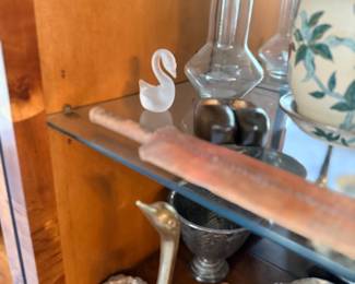 Cabinet with brass swans and glassware