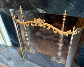Brass fireplace screen with marble surround