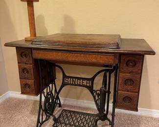 Singer Treadle Sewing Machine in Ornate Wood Cabinet with antique wooden spool