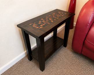 Decorative mosaic accent table in very good condition. Unique dark wood design with time top detail and lower storage shelf. $40 