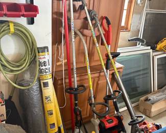 Assorted Yard Tools: Stihl String Trimmers, Voltask Electric Trimmer, Leaf Blower, Hose, and Weed Barrier