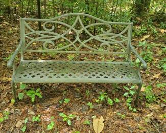 Metal garden bench styled with lattice back and scroll work details.