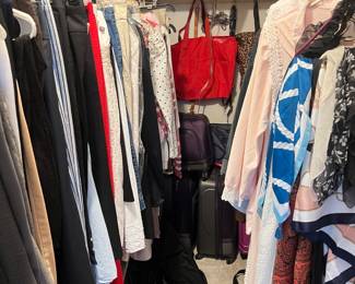 Bedroom closet full of Woman’s Clothing, Handbags, Shoes, and Luggage