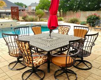 Ow Lee metal patio set includes eight swivel chairs and table. Please note the paint is flaking on the powder coat on the chairs but otherwise in good condition. Not all chairs have cushions. Umbrella sold separately