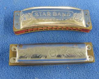 Lot 233. Two vintage harmonicas: Weiss 10-hole diatonic harmonica in the key of C. Sounds great. Unknown maker Star Band curved octave harmonica in the key of C made in Poland.